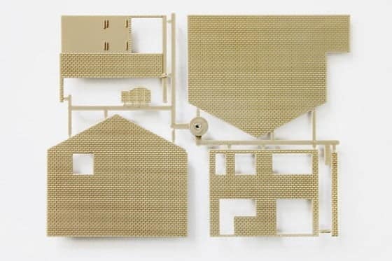 A plastic model sprue containing parts of a house