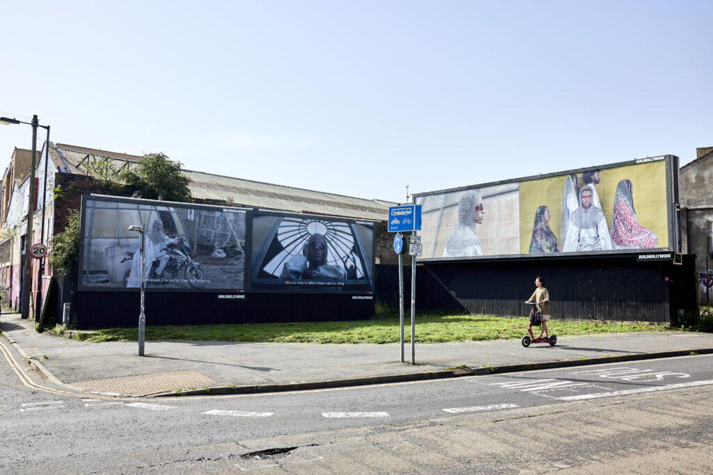 riding past billboards with artwork on them