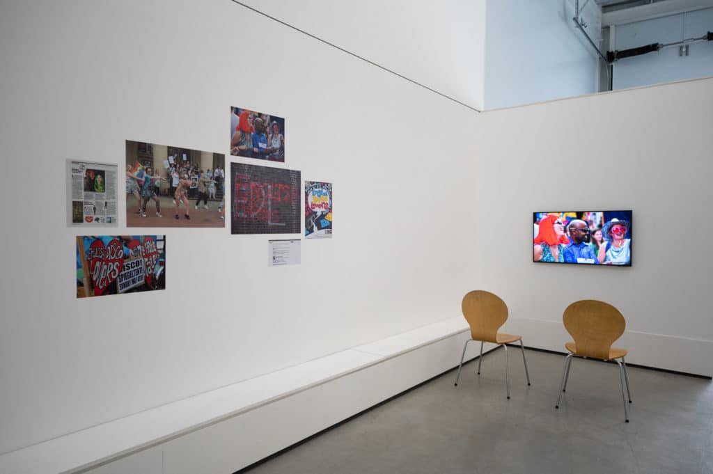 photograph showing photographs and video screen displayed on wall made by the artist Chris Alton for his exhibition at Studio Kind.