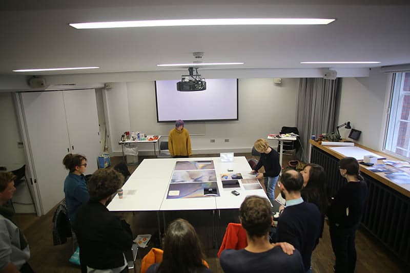 Artists discussing work around the table