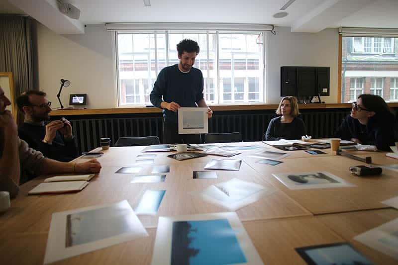 An image of a group of artists discussing work