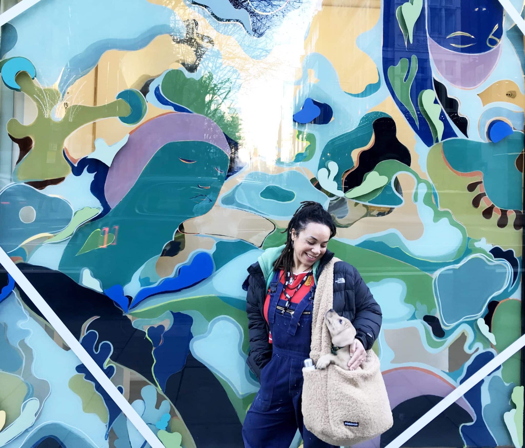 Catherine Chinatree standing in front of the Resolutions window commission