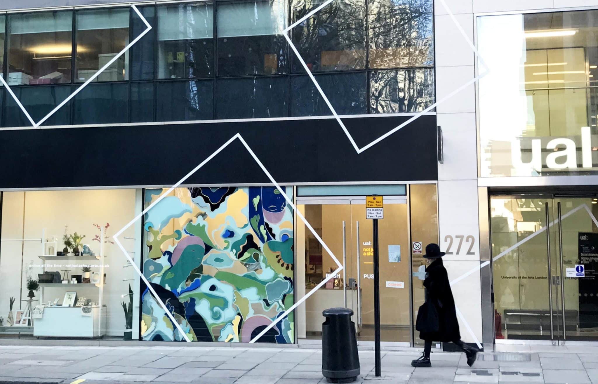 Person walking past Resolutions window commission.