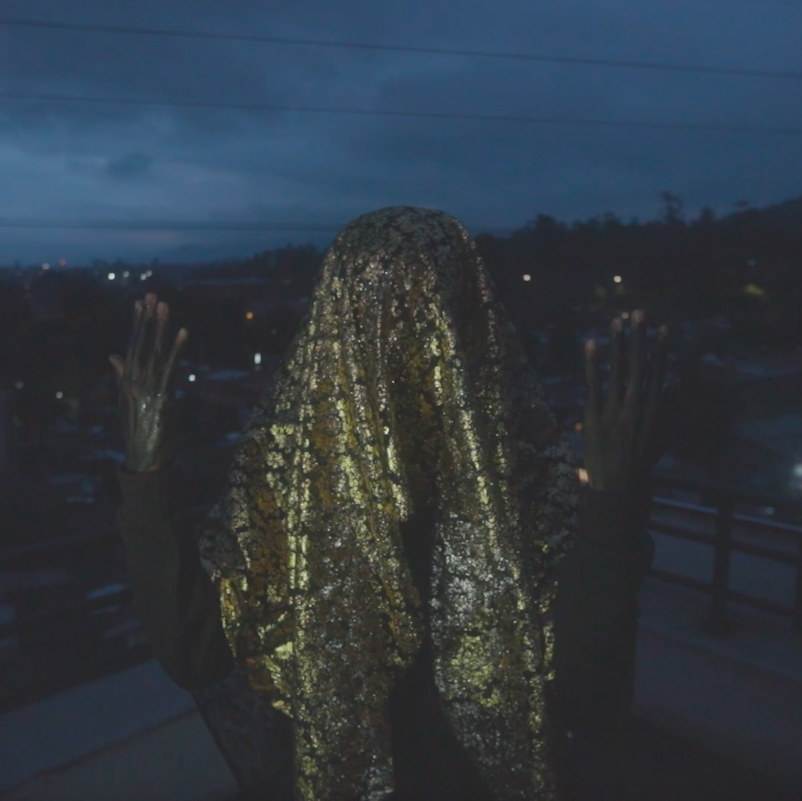 photograph taken in the dark with someone with a cloth cloth over their head