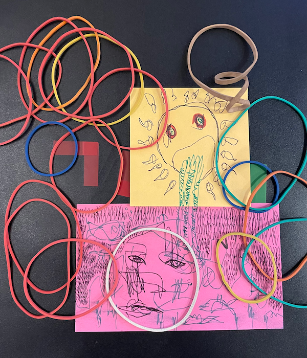 rubber bands strewn on top of a sun vomiting into the ocean