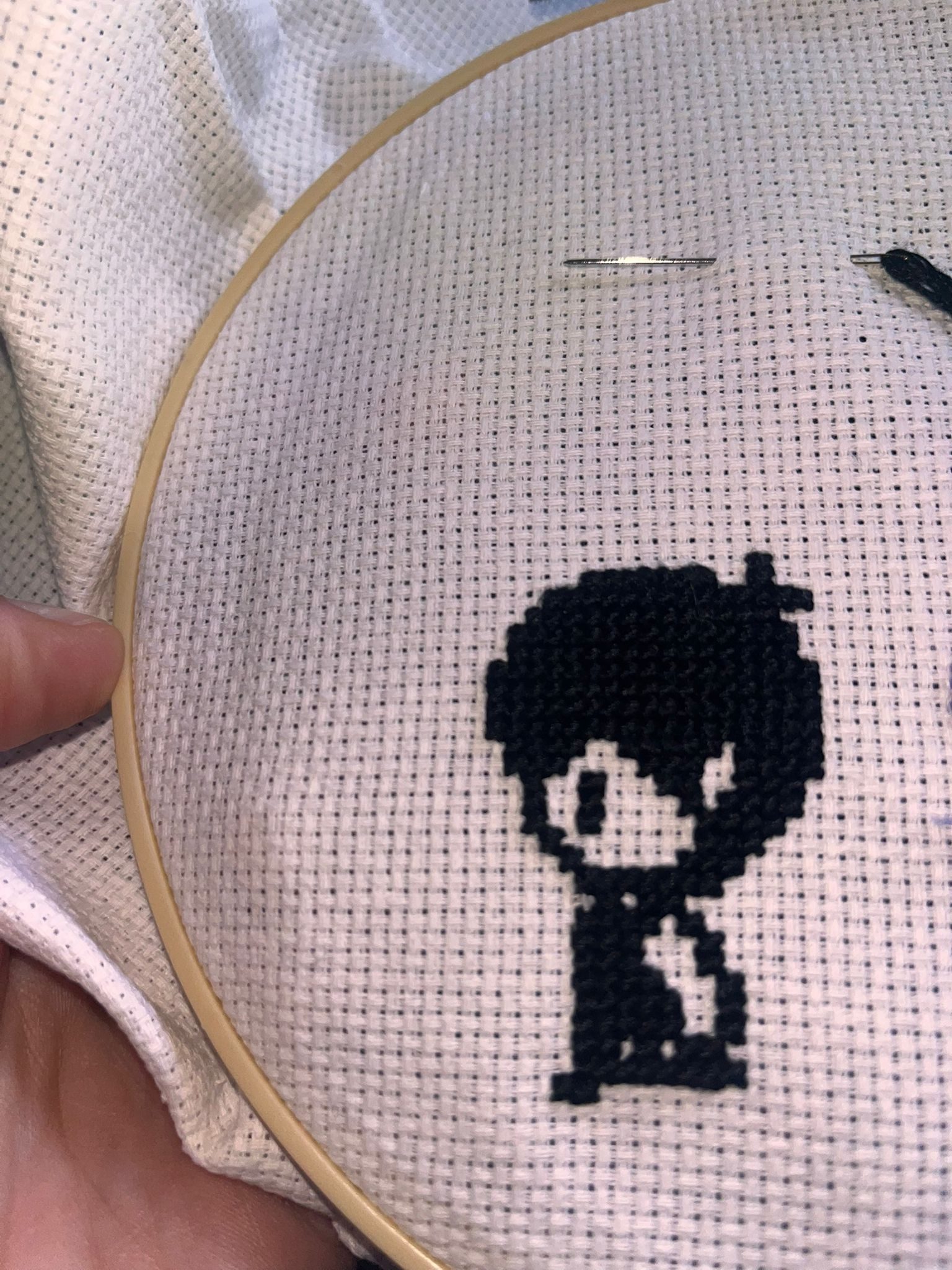 A cross stitch of Omori, a video game character