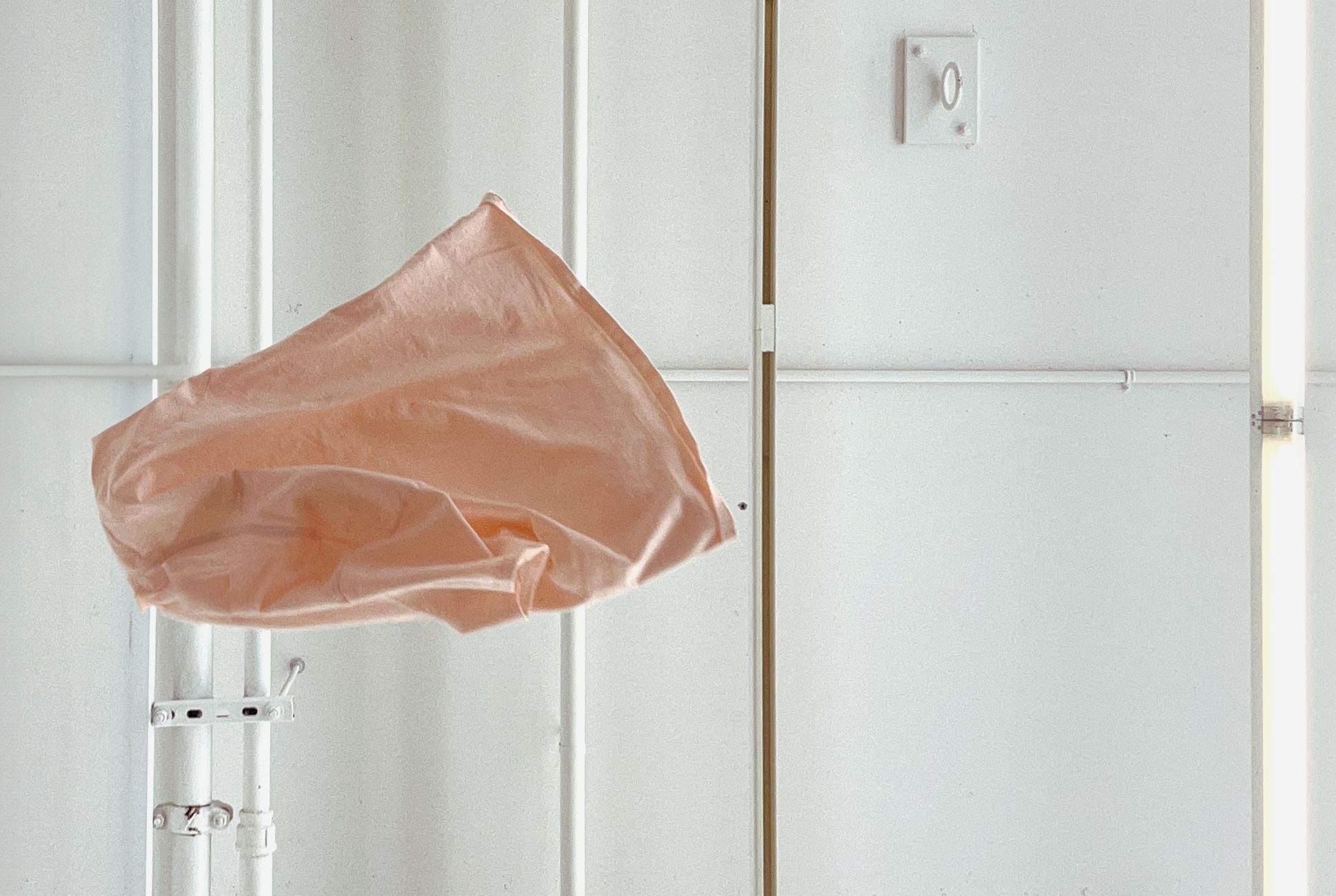 image of a pink hanes tshirt tossed in the air