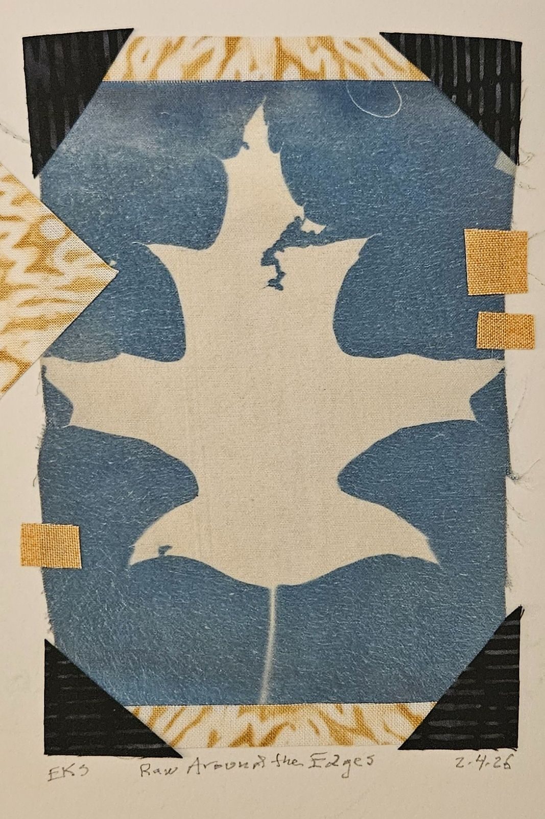 A fabric collage featuring the white silhouette of an oak leaf on a background of blue, black and yellow.