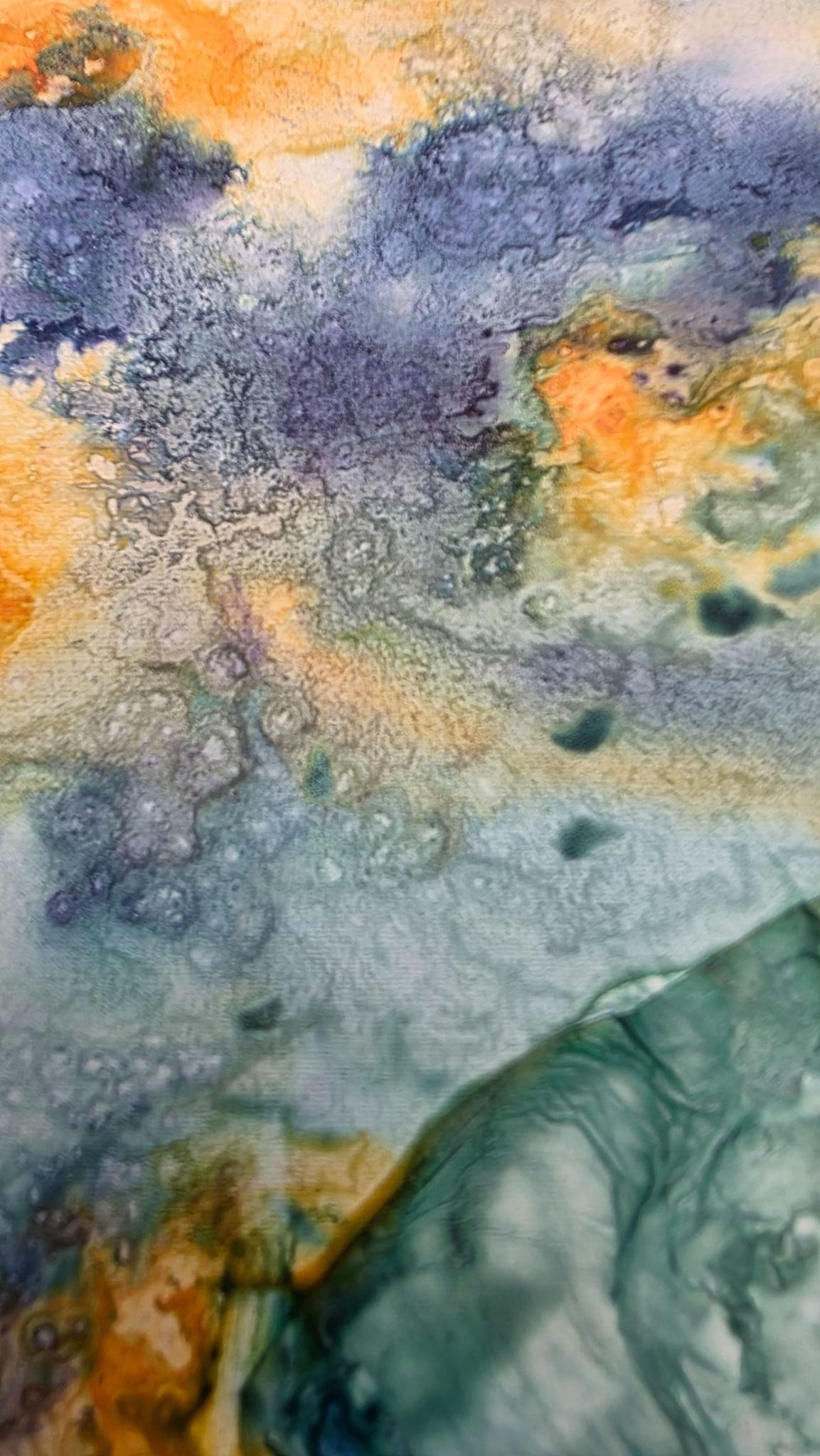 Grey and yellow watercolour - flecked with salt to create cloud like structures of an impending coming - perhaps the fiery horse of Chinese new year