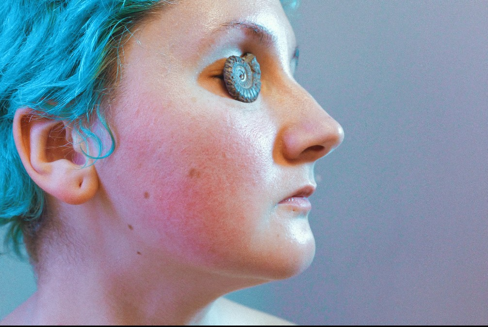 A close up of my face, with an ammonite instead of an eye.