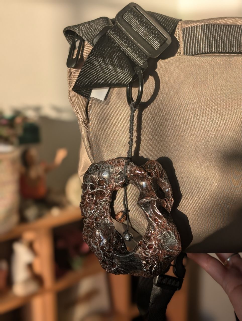 Made myself a charm made of clay and covered with watercolor and plastic. Looks like volcanic rock