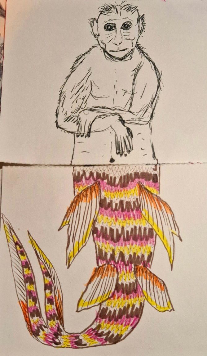 An illustration of a half fish half mermaid drawn by 2 people on 2 pieces of paper, joined at the hip