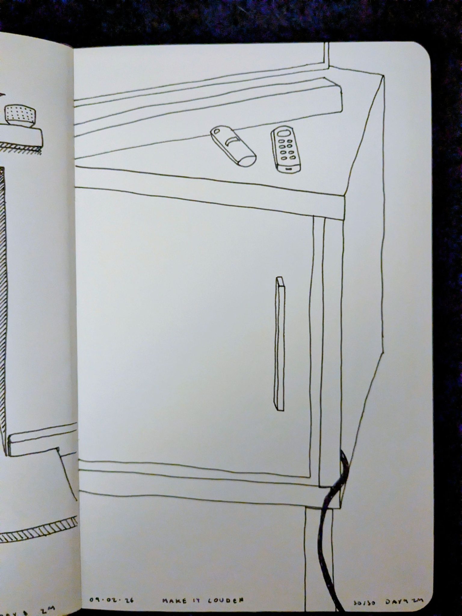 Photograph of a sketchbook page showing a line drawing of some furniture