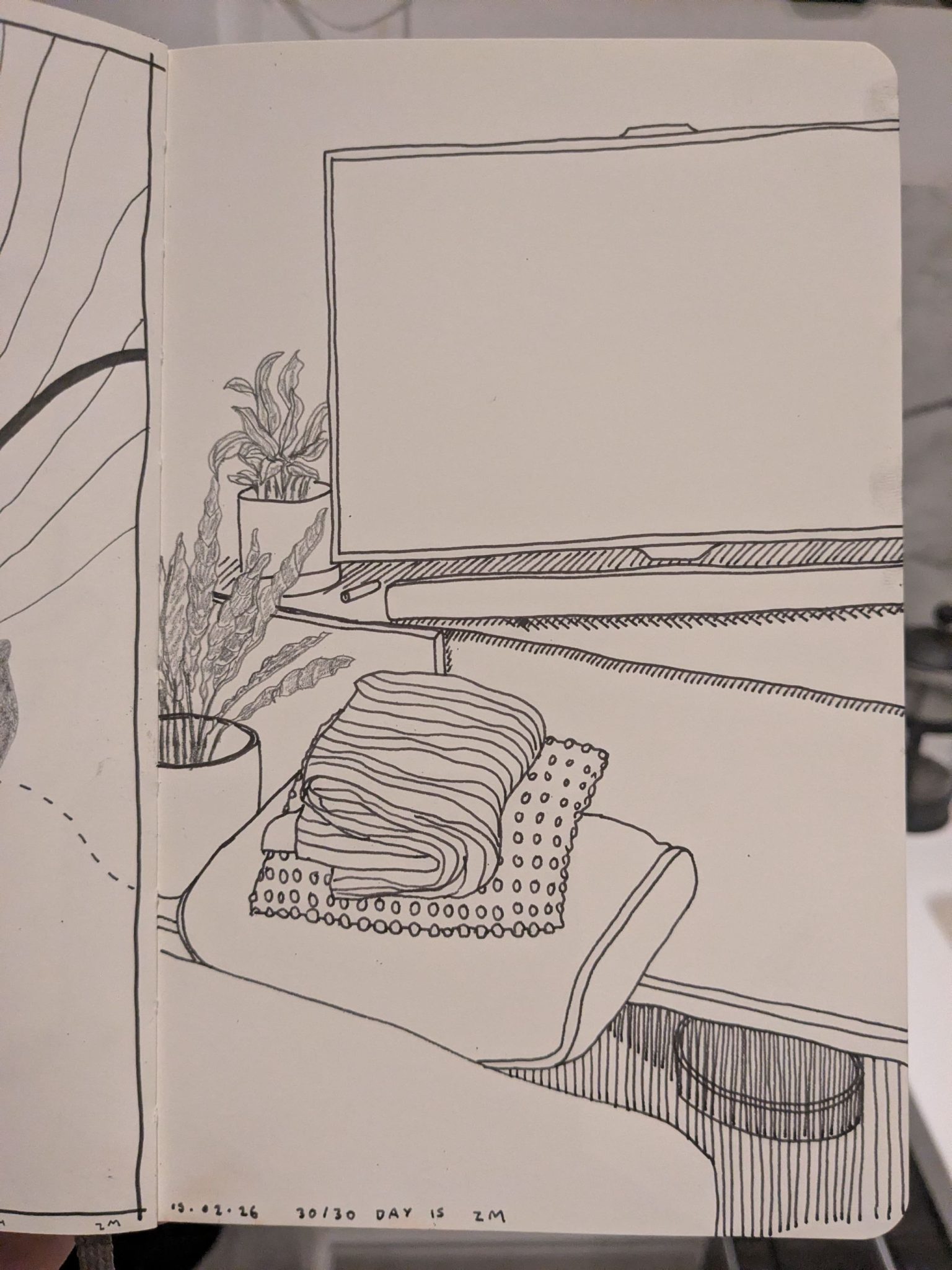 Photograph of a sketchbook page showing a pen and pencil drawing of some furniture and plants