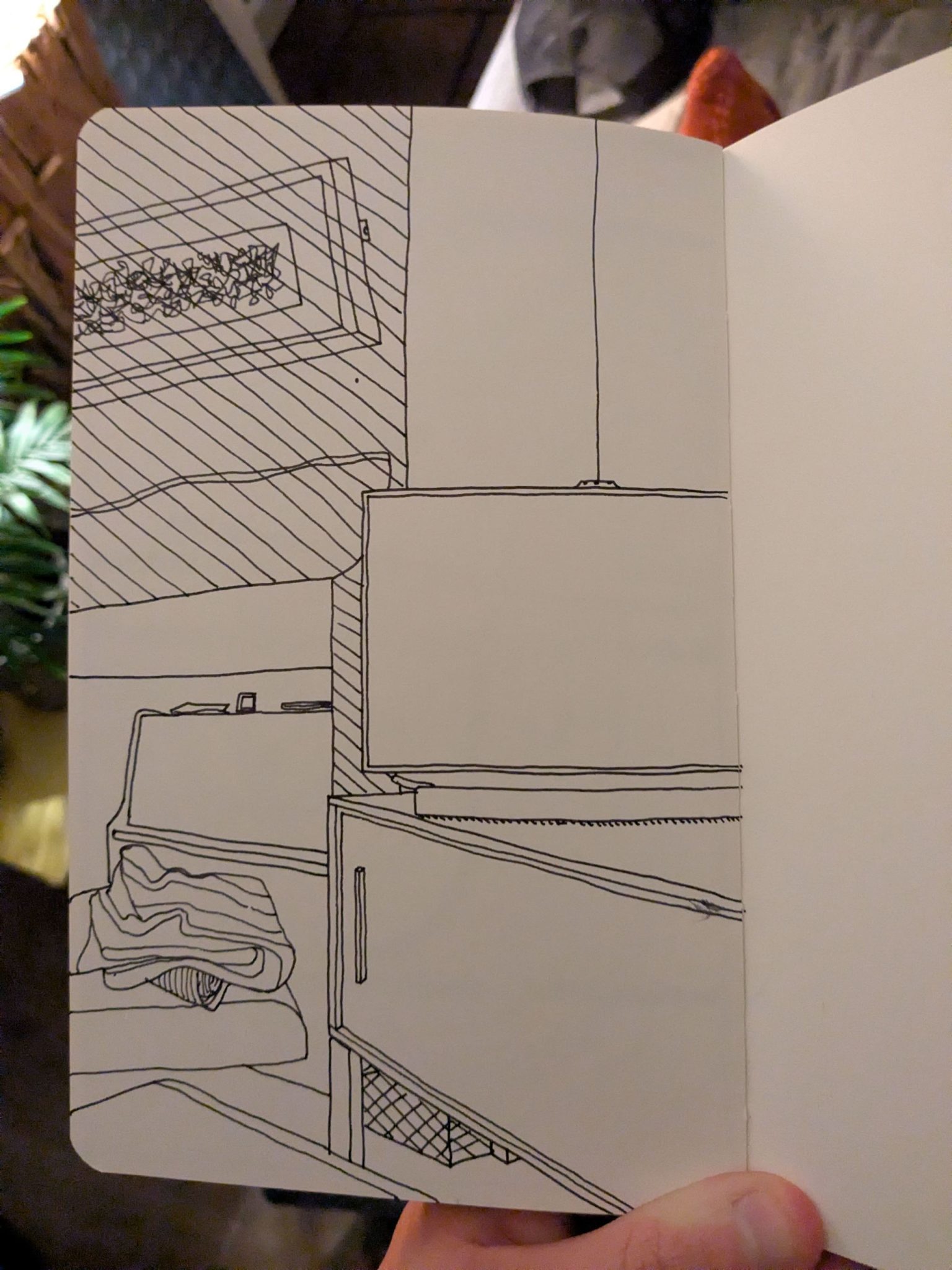 Photo of a sketchbook page showing a pen sketch