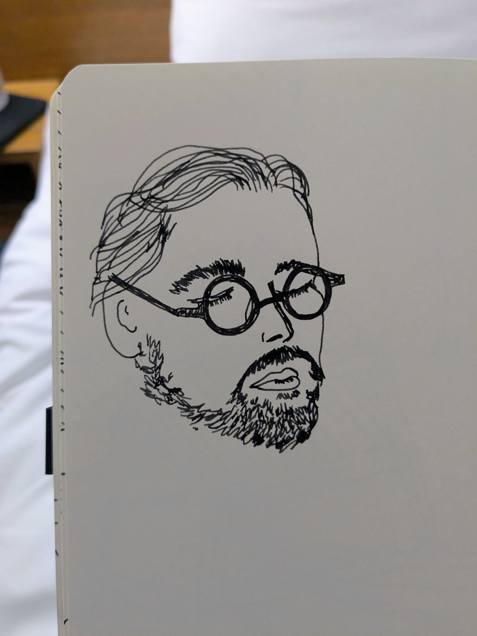 Photograph of a pen sketch of a man's face