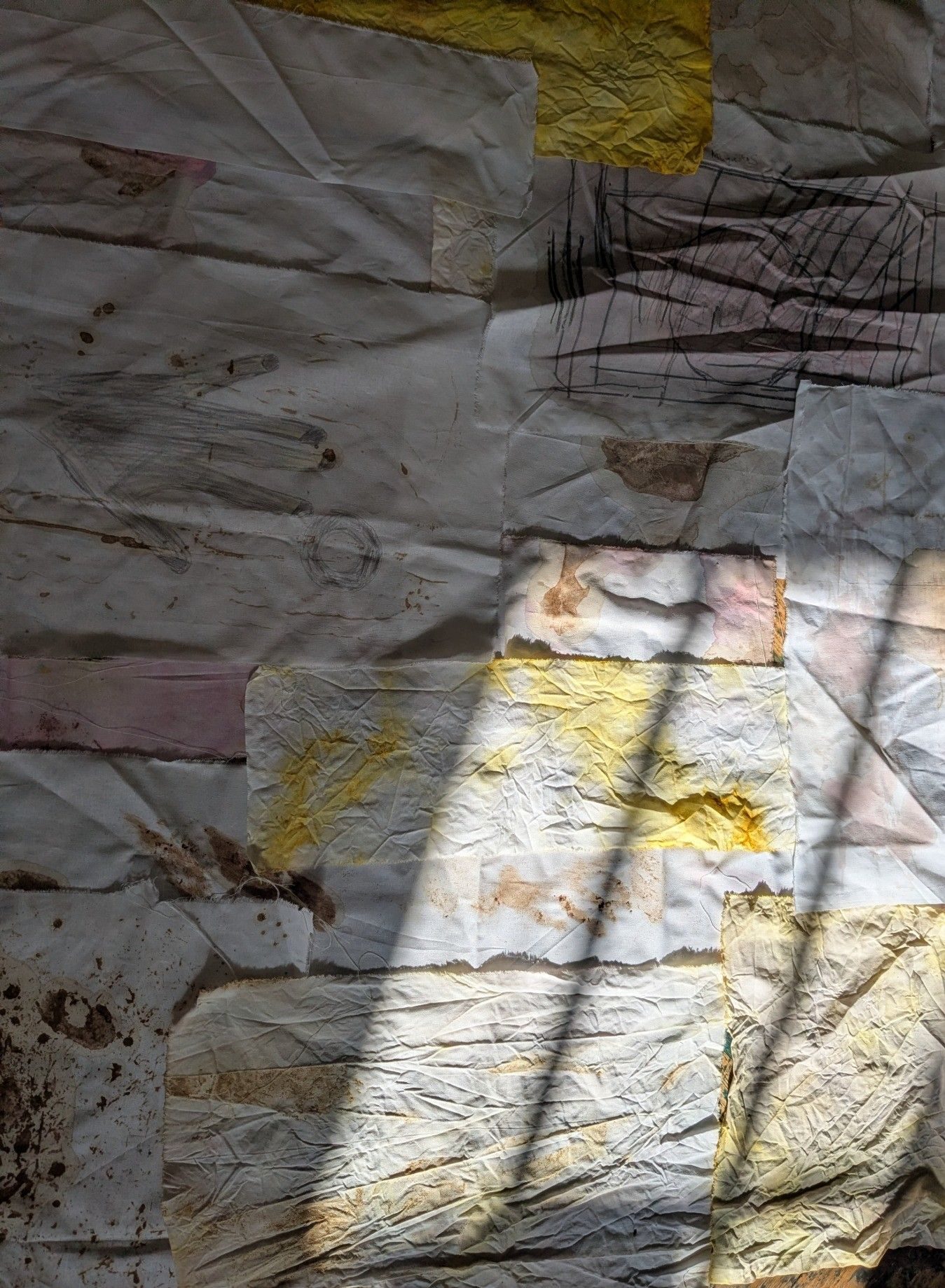 Natural dyed fabric patchworked together with the sunlight from a window shining onto it.