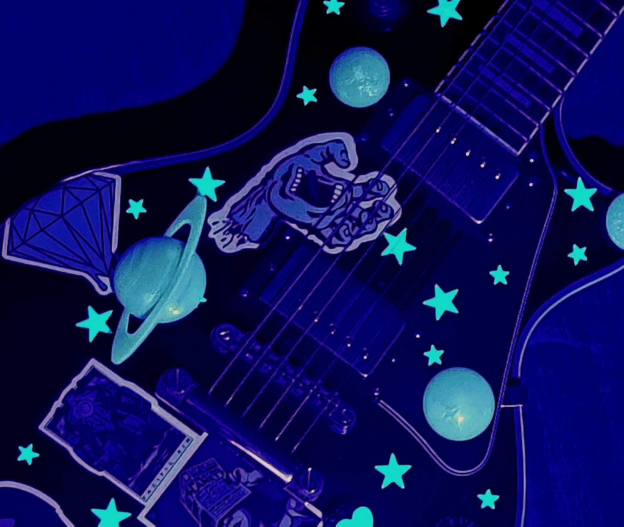 An abyss black guitar laden in stars