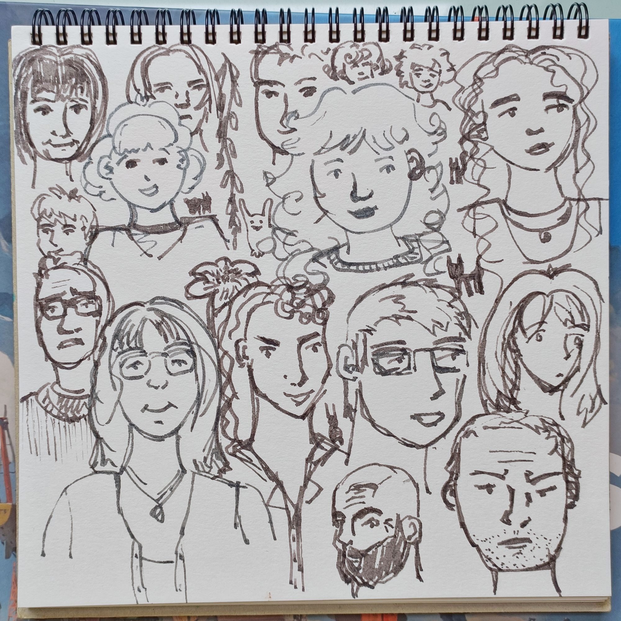 a sketchbook page filled with faces
