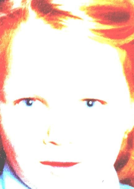 A faded image of a young face