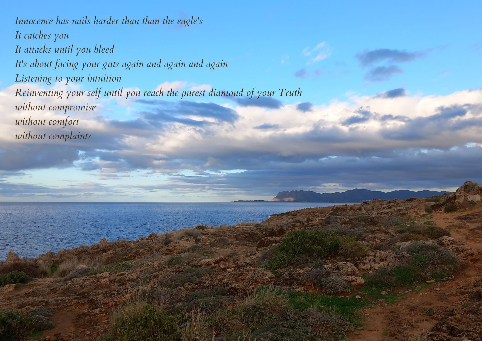 Photograph of a rocky path by the sea with text