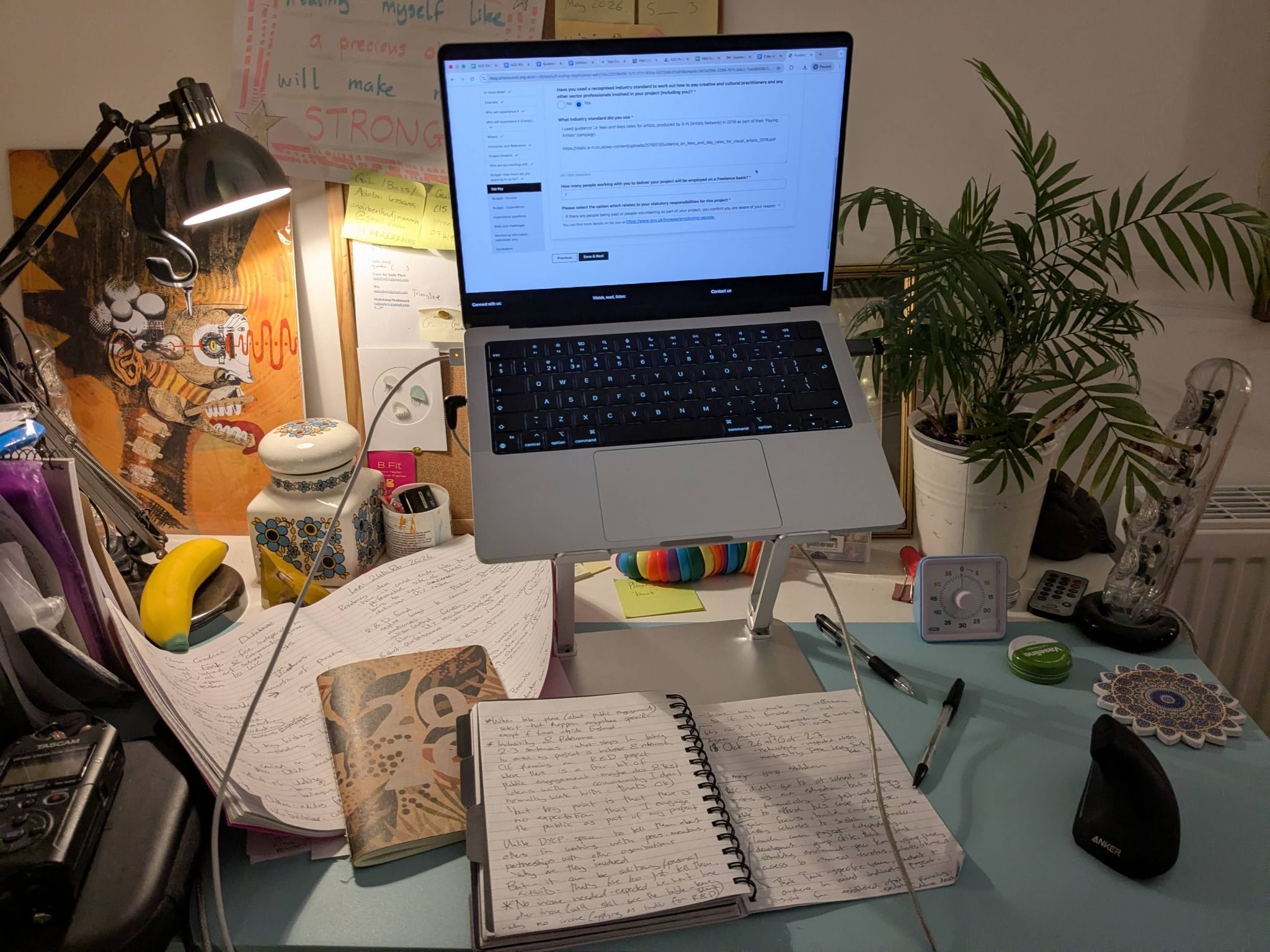 A photograph of a laptop on a workstation