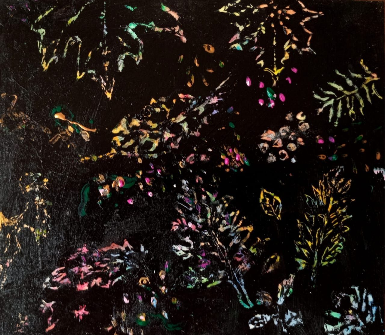 Leafy shapes scratched into black cardboard surface