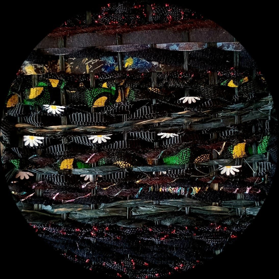 Woven piece with found thread, cut up paper drawings  in a circular shape