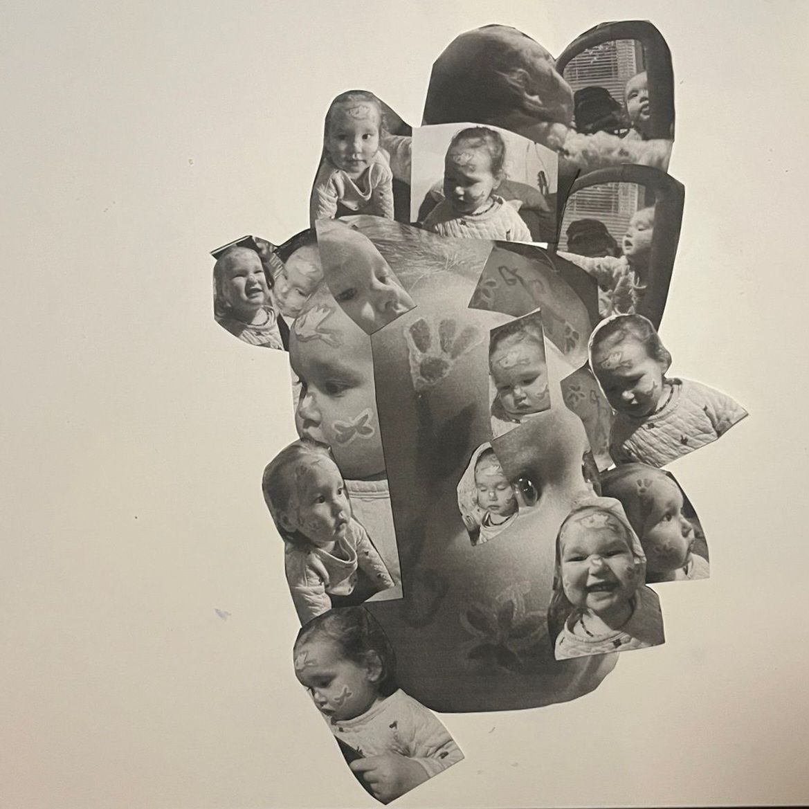 Collage in black and white of a toddler face with her face painted