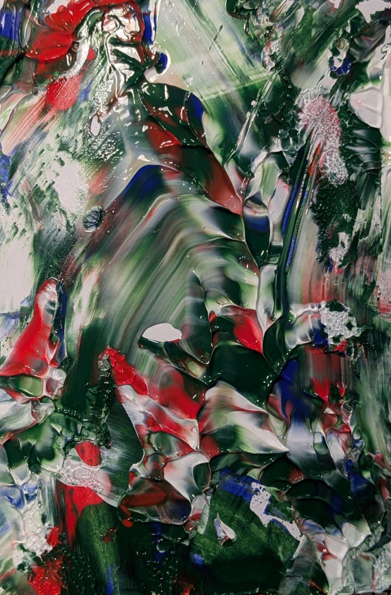 An abstract acrylic painting with mixtures of green, red, blue and white