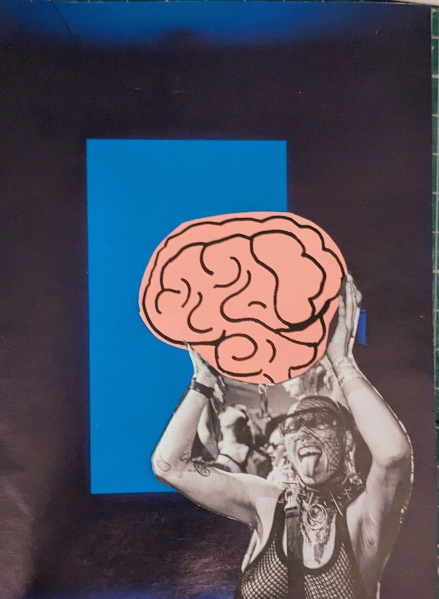A light blue rectangle sits in the middle of a dark blue rectangle, in the bottom right corner a person holds up a cartoon brain, they have their tongue out in glee and a string vest