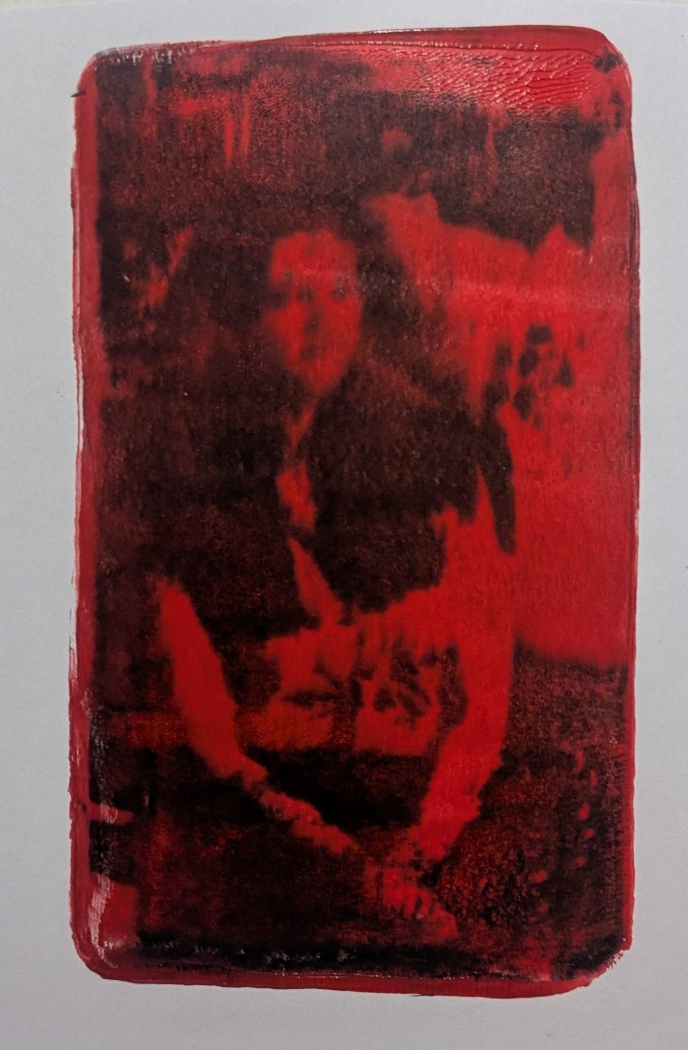 A photo transfer of a woman with contrasted red and black