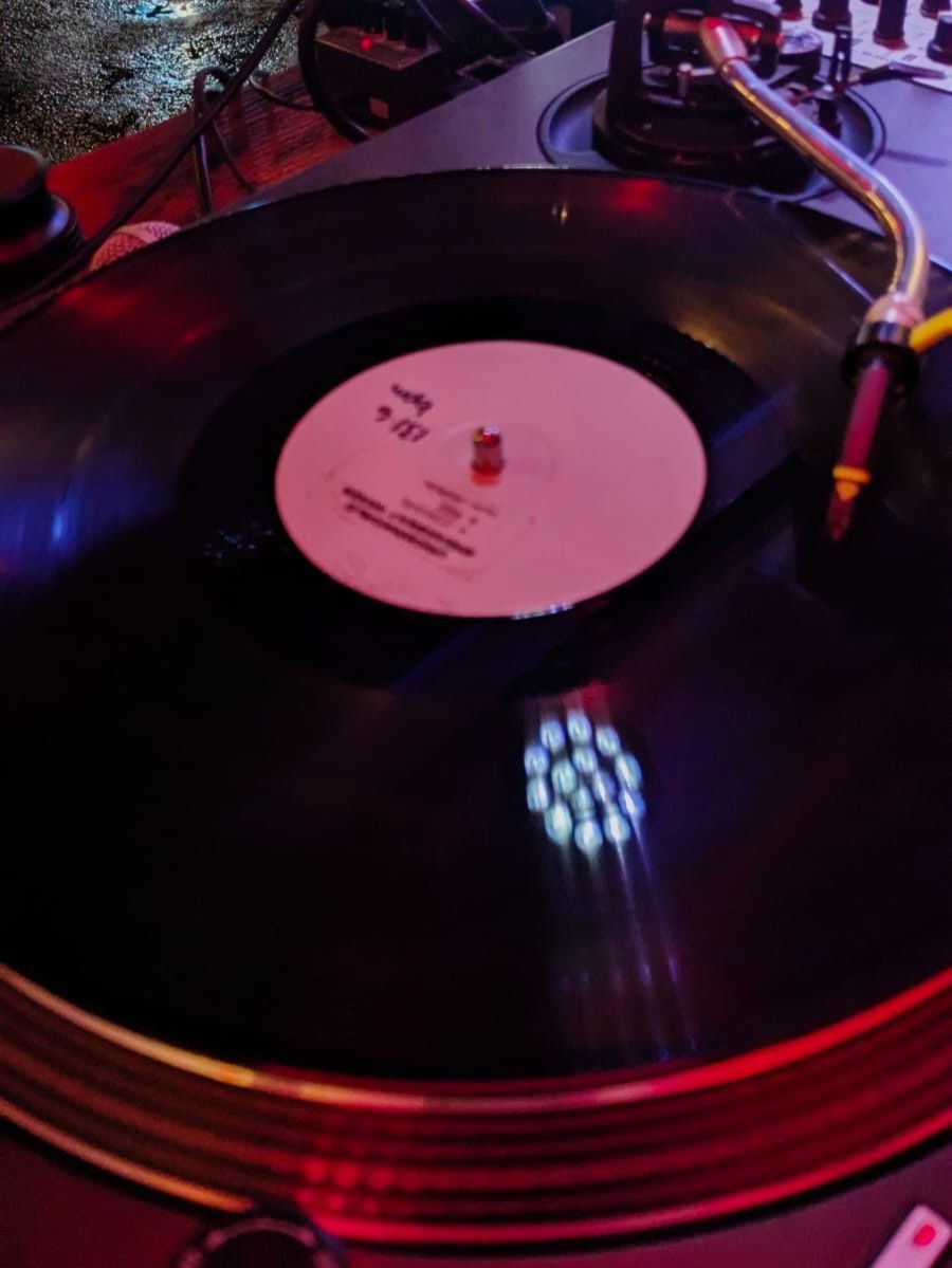 A photo of a record playing on a deck