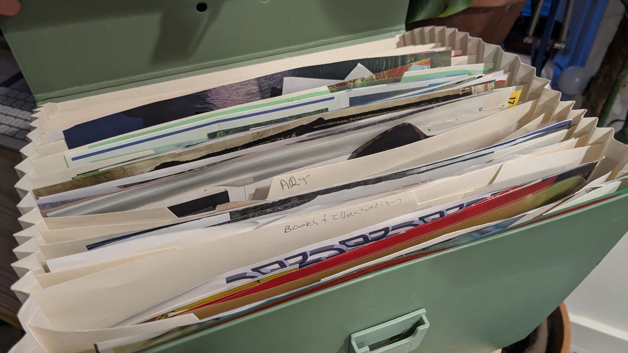 A file with different categories of cut out collage clippings inside