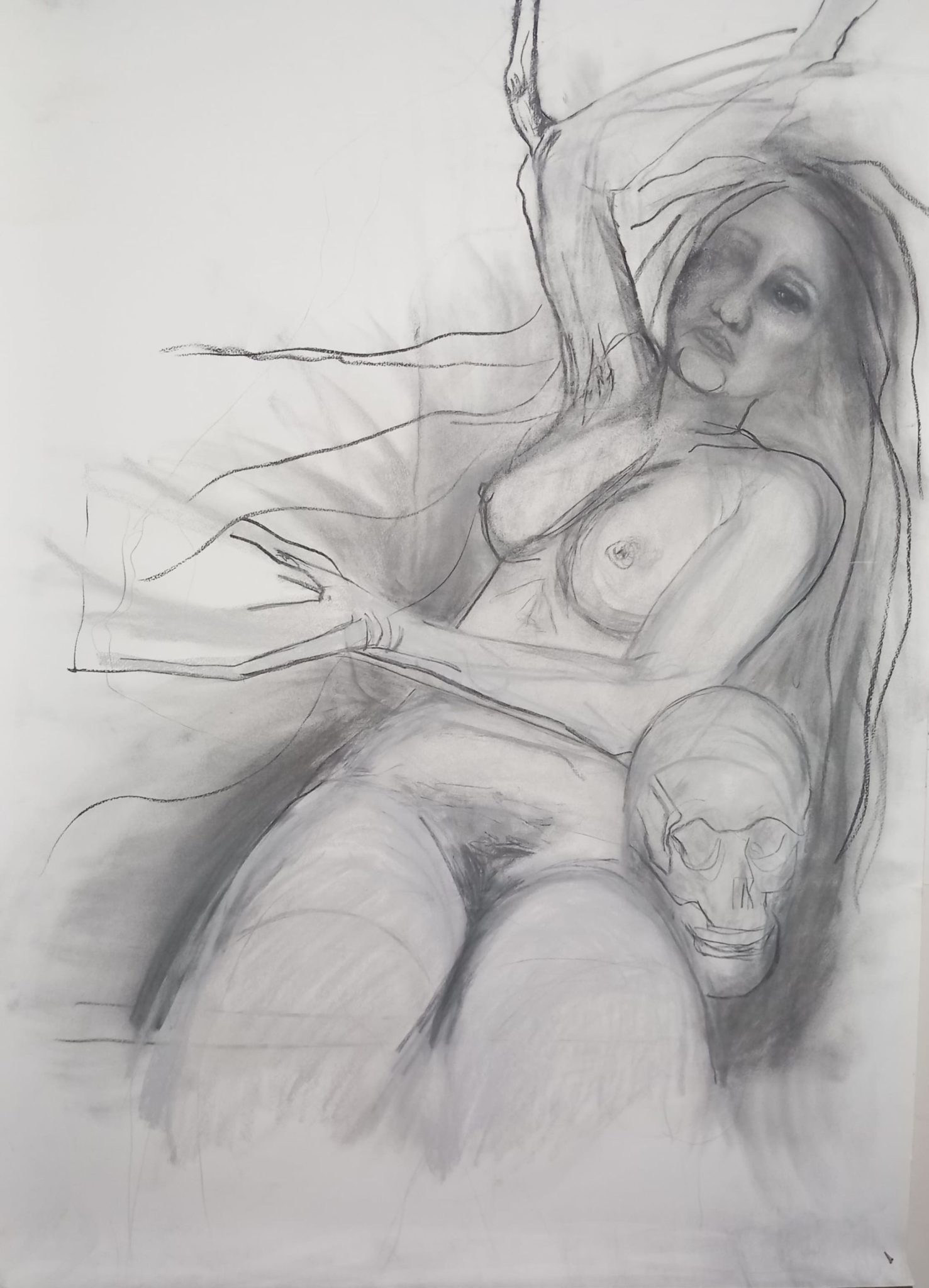 compressed charcoal and pastel sketch, idea for painting. self portrait of woman turning into or emerging from the background,  her arms and hands are becoming branches  she has a skull on her left side, she is facing the viewer and is naked.