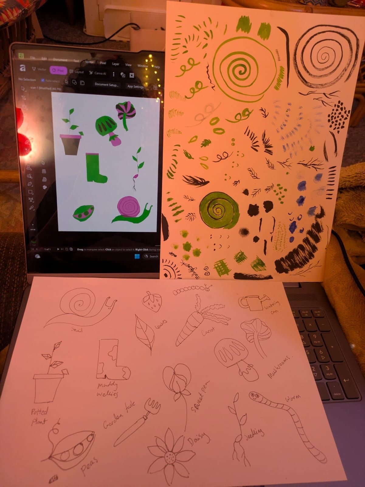 An image of a screen with a  digital drawing on the drawing is mushrooms, snail, welly boot, seedling and pot plant made from vectors. Underneath the screen is another drawing made with pen of the same objects and another to the side of some inky marks. The artist plans to combine them in the digital drawing but hasn't quite figured it out yet