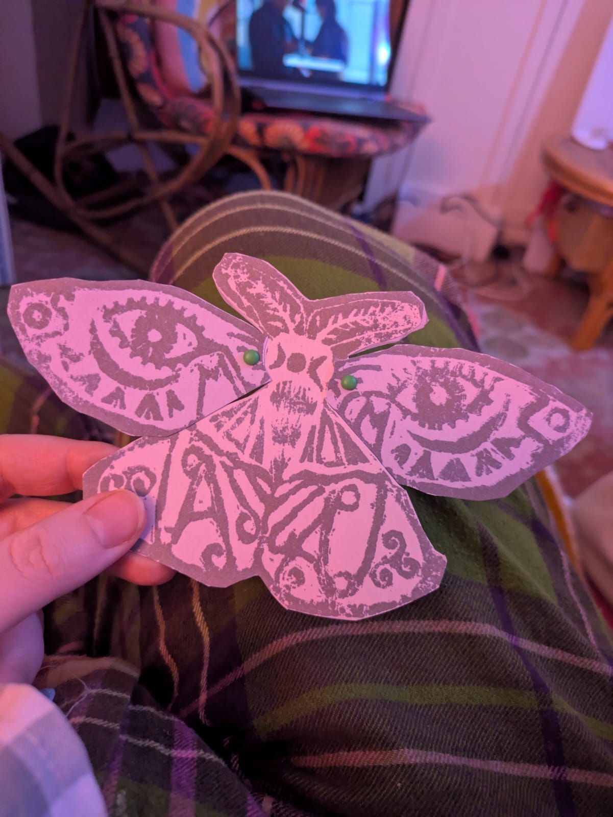 Lino cut print of a moth printed and cut out then put through with split pins to make the wings move
