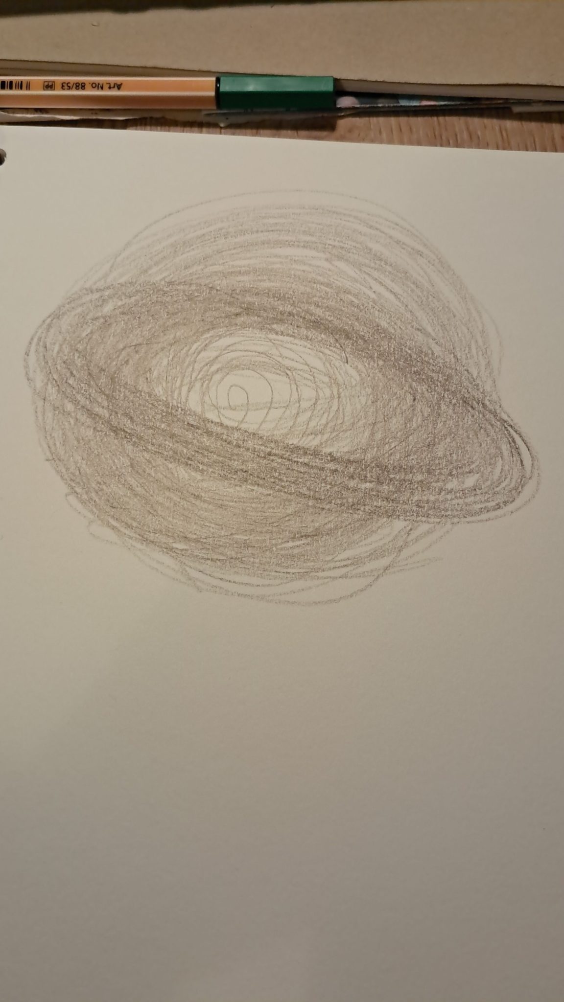 A hand drawn picture of swirls using pencil on paper