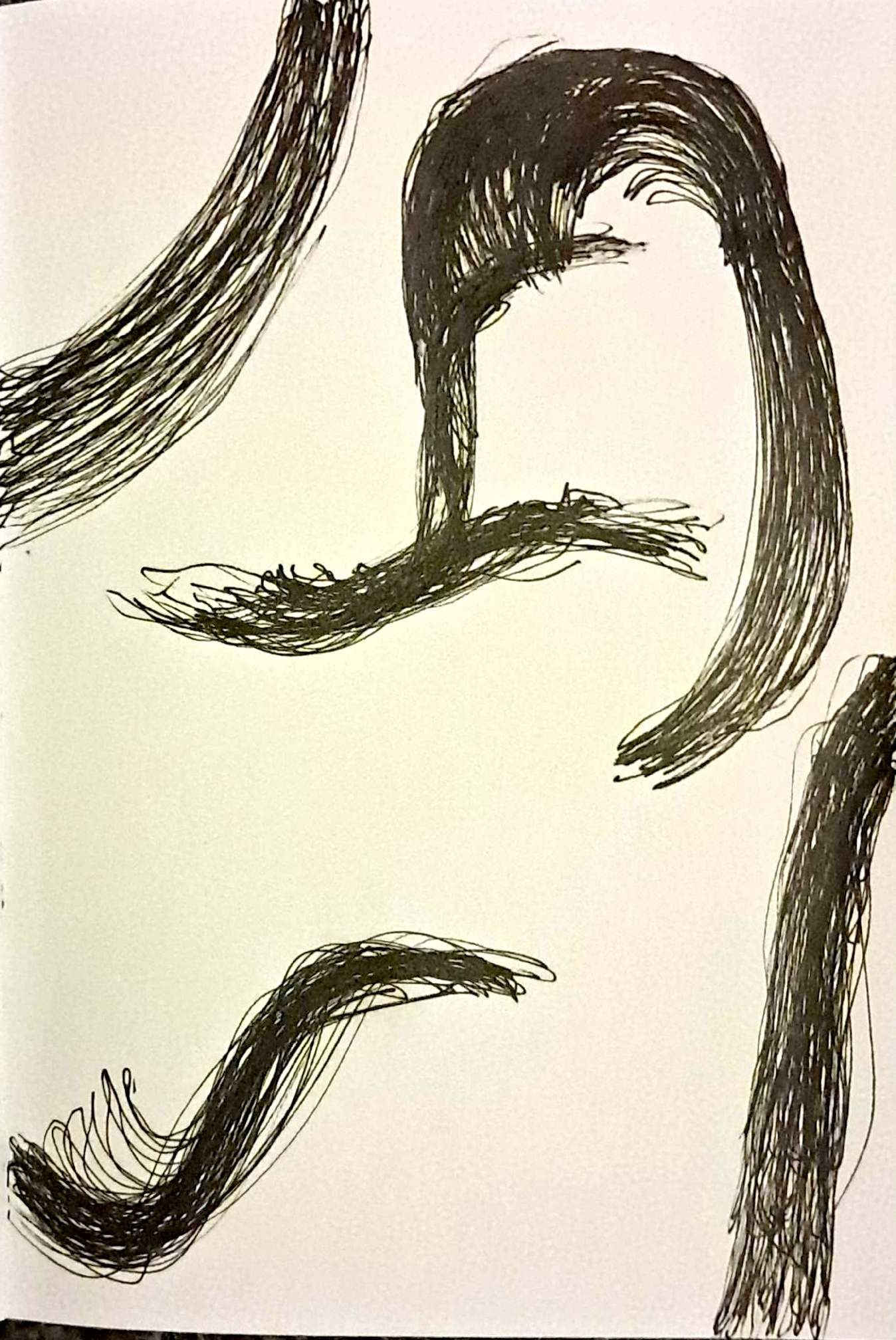 A hand drawn picture of swirls using black pen on paper