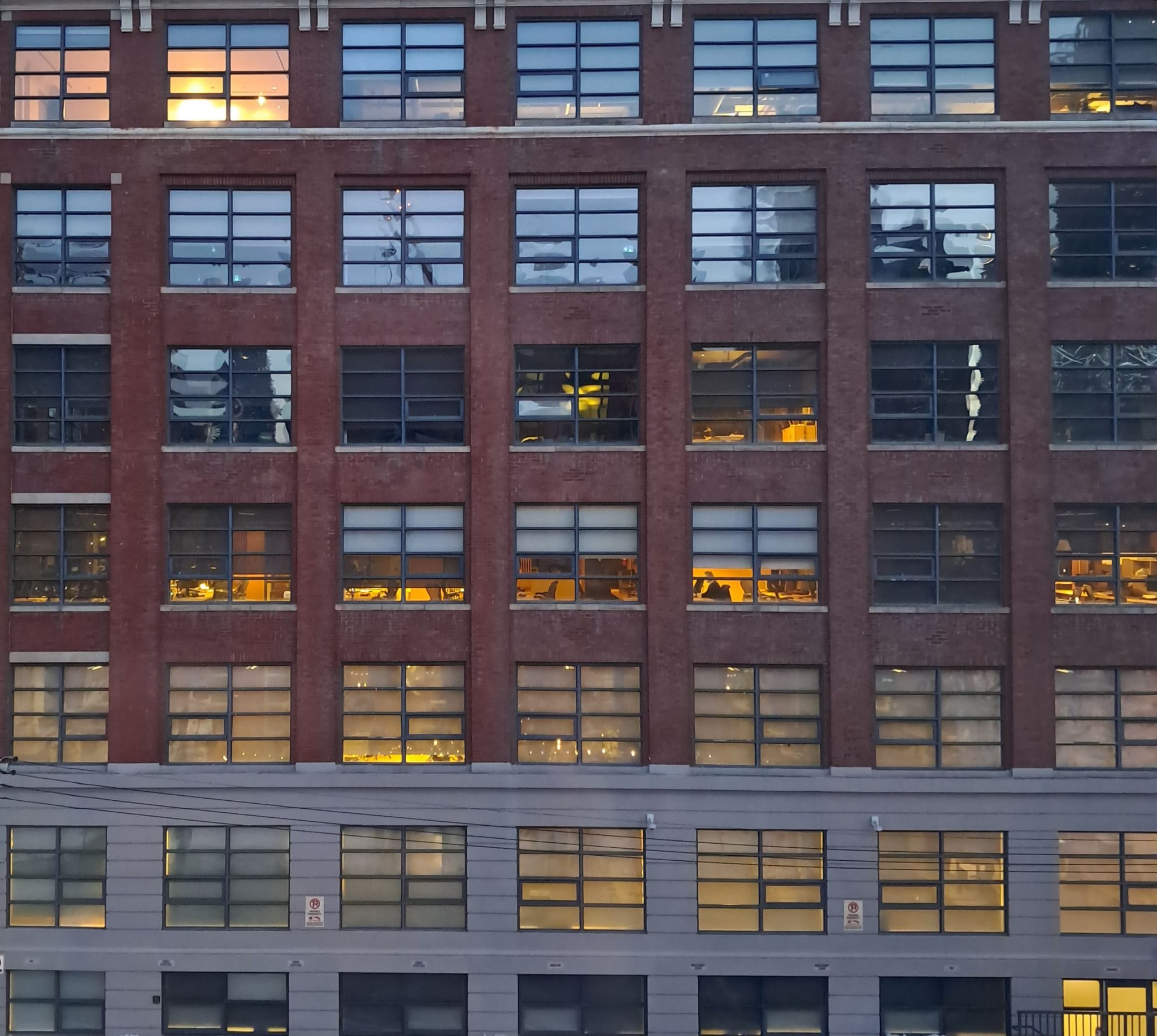 A photograph of a building with symmetrical windows and lights