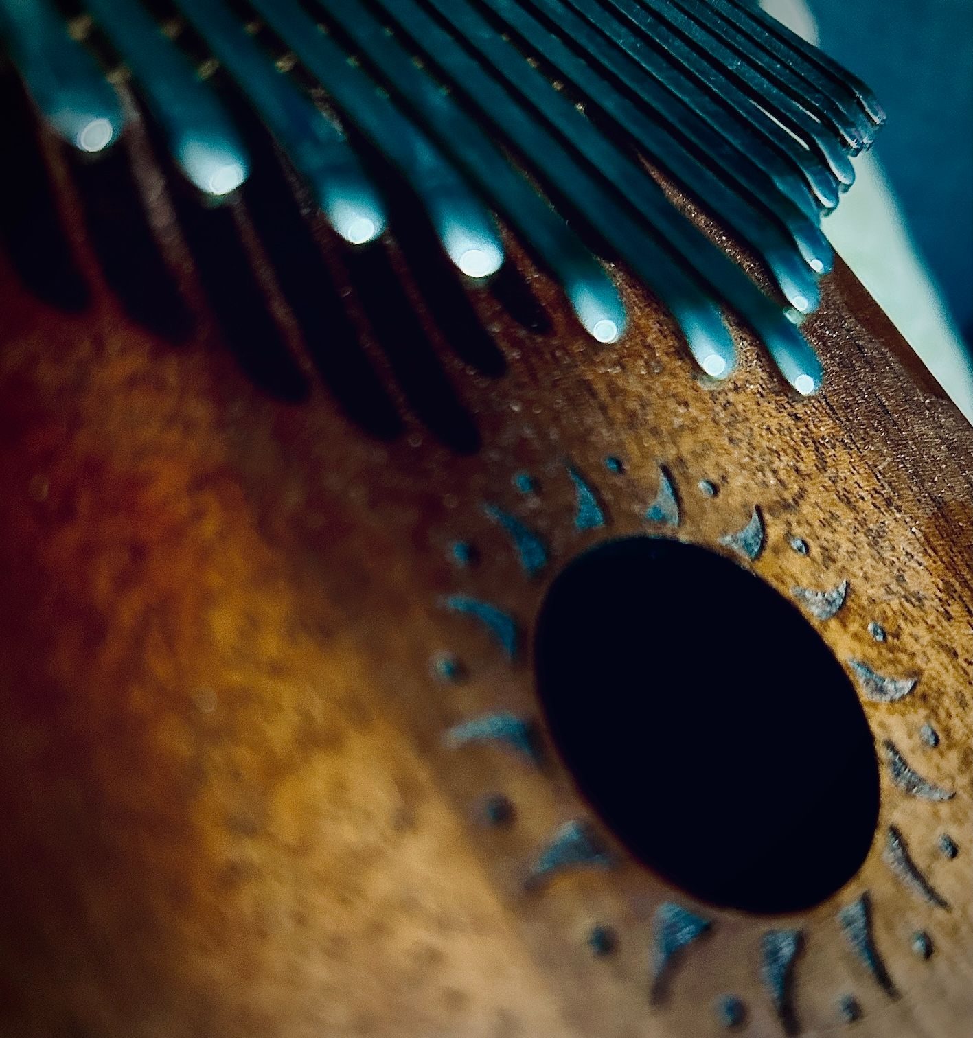 Close up photo of metal lugs on a wooden background and a circular hole in the wood
