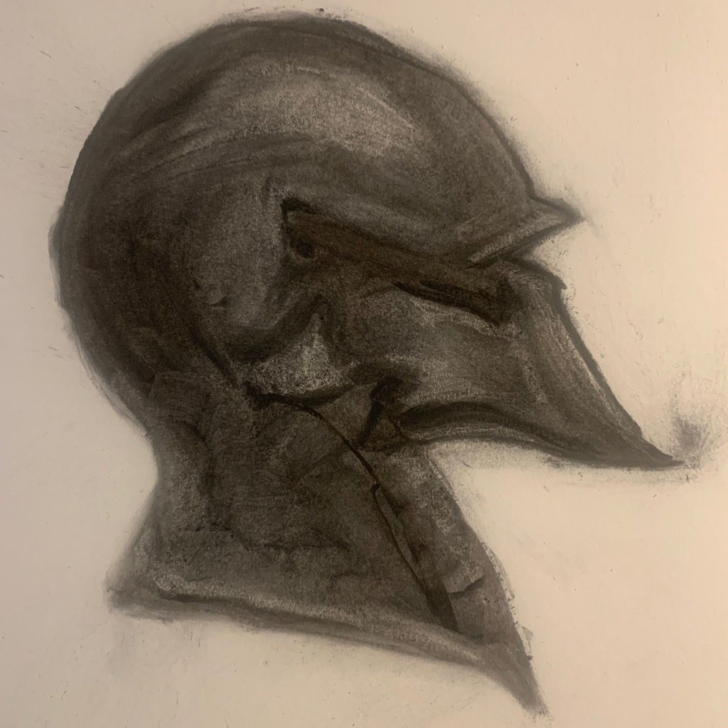 A slightly abstracted charcoal drawing of a knights helmet in profile from facing to the right.