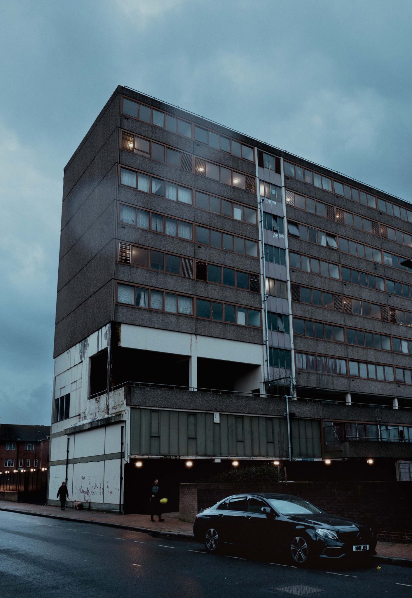 Aylesbury estate with black Mercedes at dusk