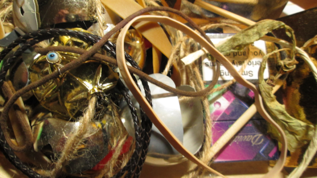 corvid's occupy the trees and the magpies wind up the cat who gazes out to see them chatter and swoop across his filed of vision, magpies are renown for hunting raiding nests of songbirds for fleddginlins and building untidy nests up in the  `London Plain trees,. They re known for linking shiny bright objects which they use their skill to steal and hoard, the image is replete with shiny objects and debris that might be ideal for nest making or just because they glitter int he sunlight , baubles, string, plaited leather a sacred eye charm, shiny cigarette box, shoelace that might be an exotic worm?, an elastic band, and hairy garden string, broken baubles, a rich hoard for any nest .a