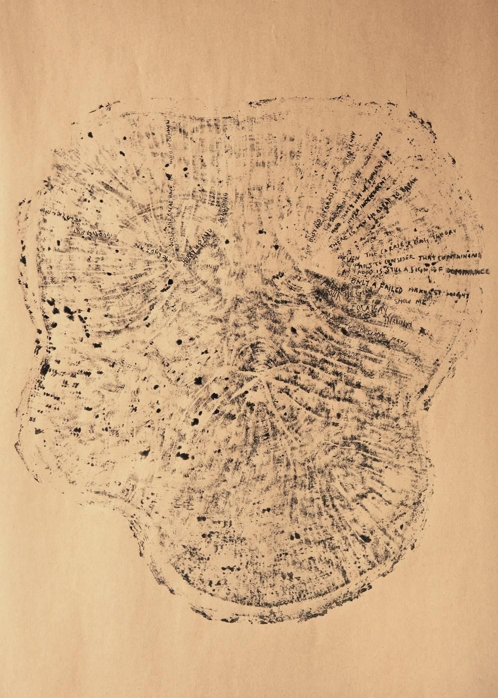 Ink print of a tree cross-segment with writing on it