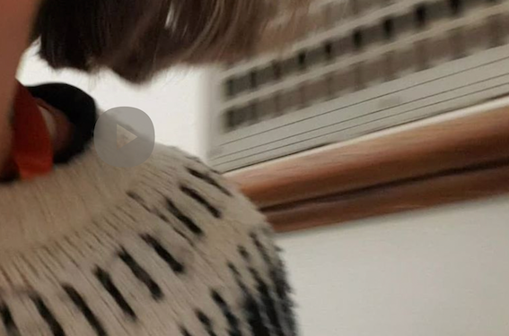still from a video of someone wearing a green fairisle jumper