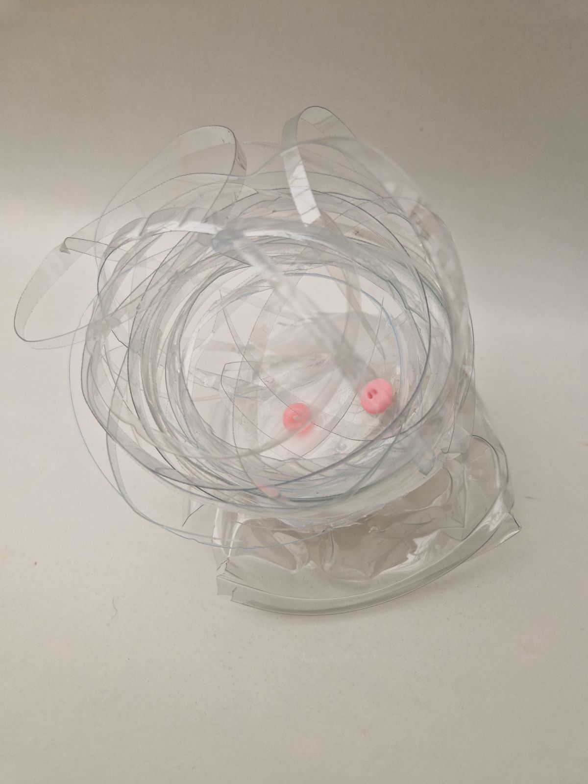 Wrapped fishing line waste with plastic beads