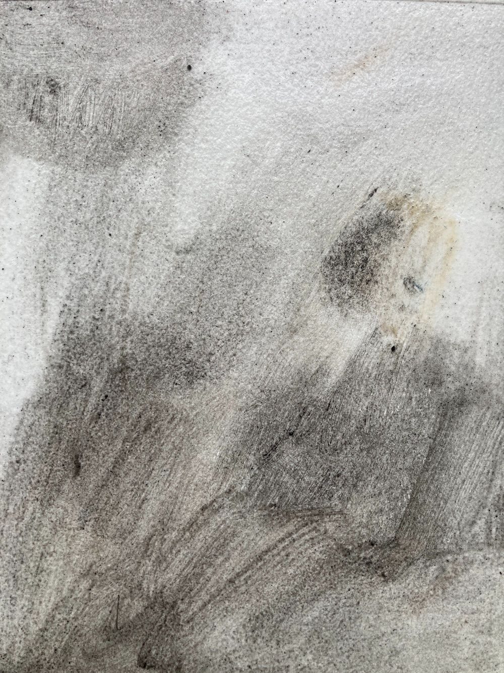 An abstract painting using ground up sea coal from Amble. The painting is an atmospheric landscape in black, grey and off white.