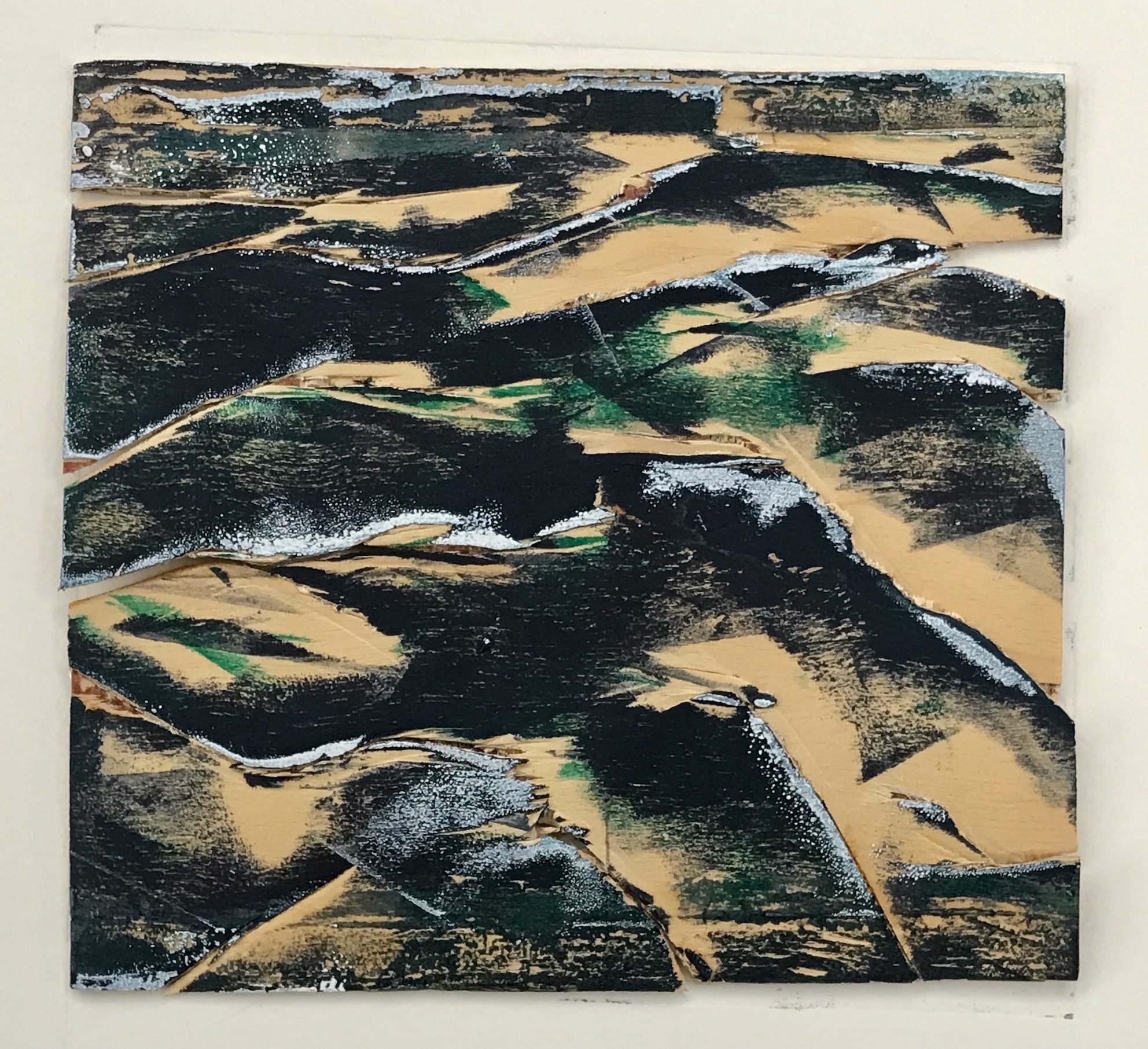 Photo of a rectangle of plywood cut abstractly, perhaps suggesting rough water, and inked with highlights of blue black, green and white with parts of the plywood left uninked.