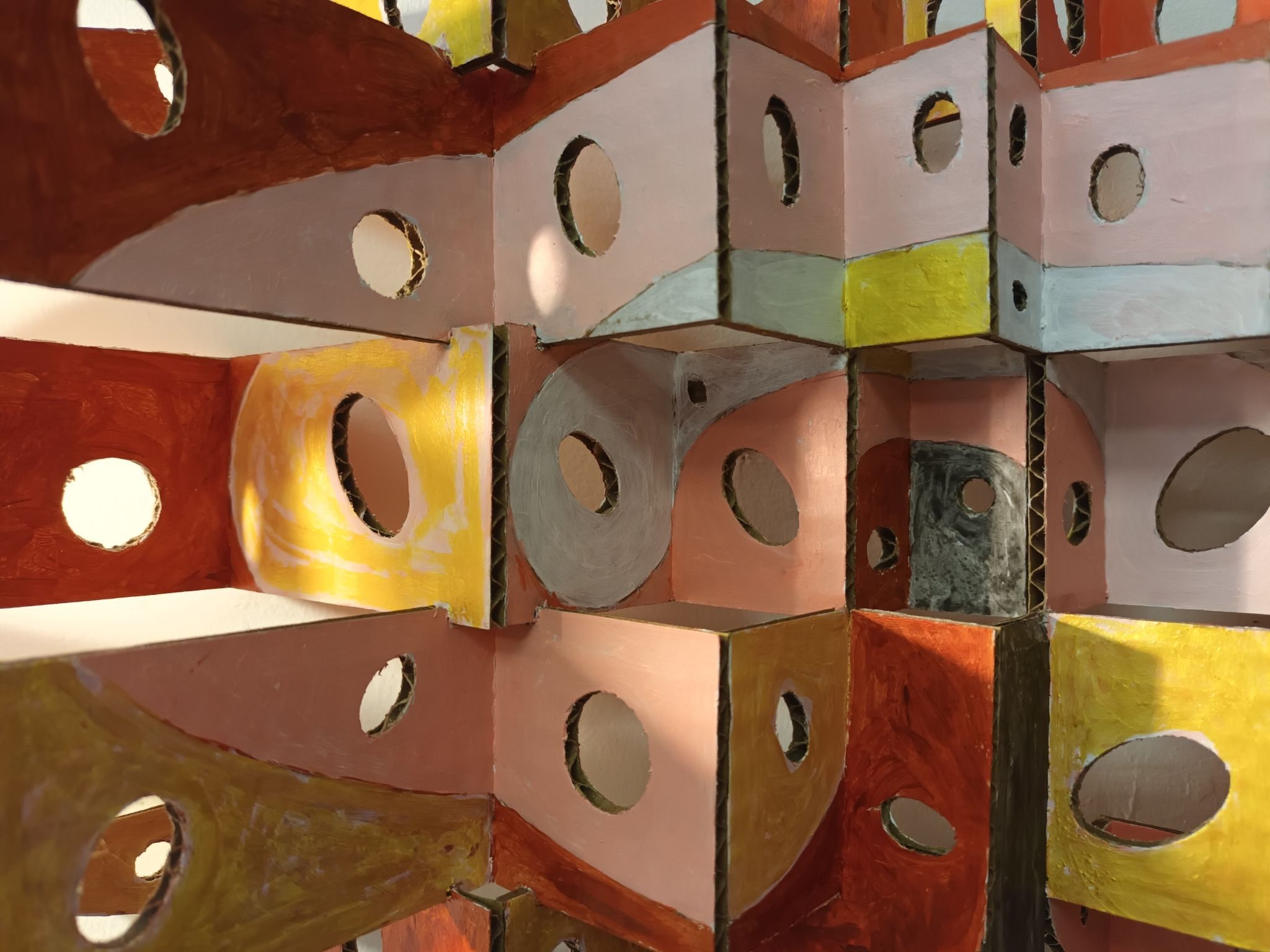 Detail of structure in painted cardboard with cut out circles